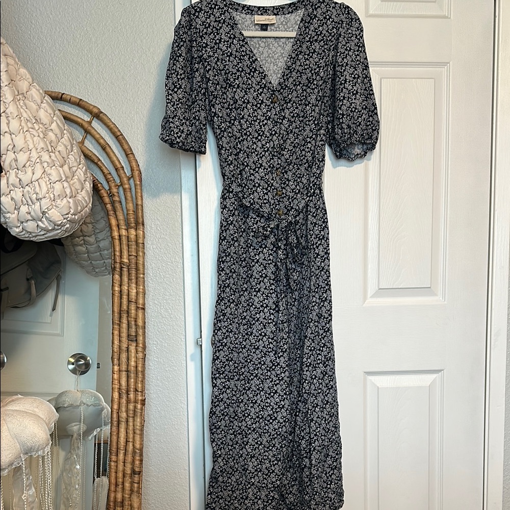 Floral navy blue and white jumpsuit with front pockets and buttons